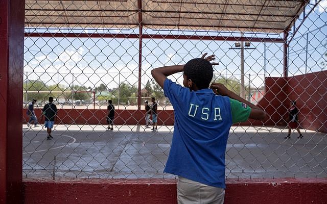 One of the residents of Iglesia Metodista "El Buen Pastor" migrant shelter watches the soccer match at a park near the shelter on June 09, 2019. (Paul Ratje / AFP) One of the residents of Iglesia Metodista "El Buen Pastor" migrant shelter watches the soccer match at a park near the shelter on June 09, 2019. (Paul Ratje / AFP)