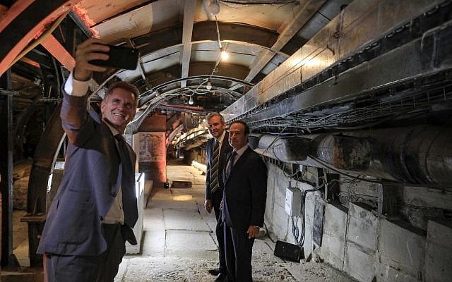 A man uses a phone to take a selfie inside an ancient tunnel during the opening of an ancient road at the City of David archaeological and tourist site in the Palestinian neighborhood of Silwan in East Jerusalem on June 30, 2019. (Tsafrir Abayov / POOL / AFP) A man uses a phone to take a selfie inside an ancient tunnel during the opening of an ancient road at the City of David archaeological and tourist site in the Palestinian neighborhood of Silwan in East Jerusalem on June 30, 2019. (Tsafrir Abayov / POOL / AFP)