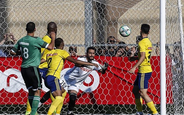 Khadamat Rafah Club's goalkeeper leaps to save the ball during the during a game in Rafah in the southern Gaza Strip on June 30, 2019. (SAID KHATIB / AFP) Khadamat Rafah Club's goalkeeper leaps to save the ball during the during a game in Rafah in the southern Gaza Strip on June 30, 2019. (SAID KHATIB / AFP)