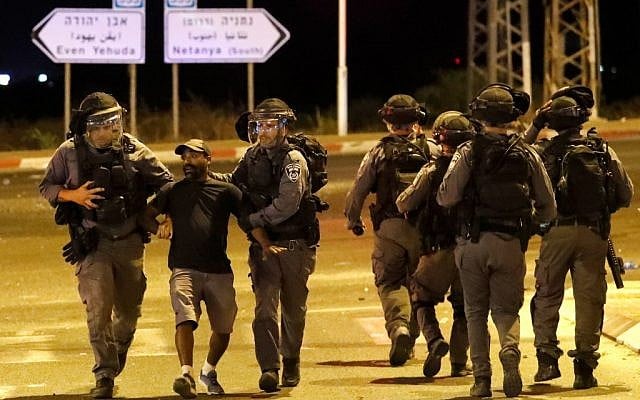 A member of the Ethiopian community of Israel is arrested by the police during clashes in the Israeli coastal city of Netanya on July 2, 2019, during a protest against the killing of Solomon Tekah, a young man of Ethiopian origin, who was killed by an off-duty police officer. (JACK GUEZ / AFP) A member of the Ethiopian community of Israel is arrested by the police during clashes in the Israeli coastal city of Netanya on July 2, 2019, during a protest against the killing of Solomon Tekah, a young man of Ethiopian origin, who was killed by an off-duty police officer. (JACK GUEZ / AFP)