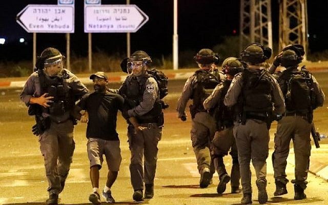 A member of the Ethiopian community of Israel is arrested by the police during clashes in the Israeli coastal city of Netanya on July 2, 2019, during a protest against the killing of Solomon Tekah, a young man of Ethiopian origin, who was killed by an off-duty police officer. (Photo by JACK GUEZ / AFP) A member of the Ethiopian community of Israel is arrested by the police during clashes in the Israeli coastal city of Netanya on July 2, 2019, during a protest against the killing of Solomon Tekah, a young man of Ethiopian origin, who was killed by an off-duty police officer. (Photo by JACK GUEZ / AFP)