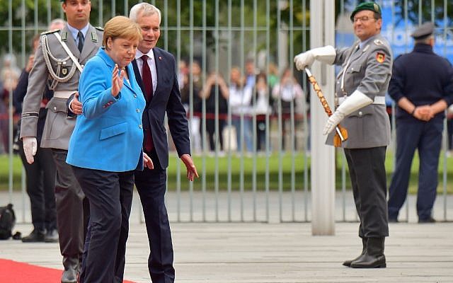 German Chancellor Angela Merkel and Finland's Prime Minister Antti Rinne (3rdL) walk after listening to the national anthems during a welcoming ceremony with military honours at the Chancellery in Berlin on July 10, 2019. (Tobias SCHWARZ / AFP) German Chancellor Angela Merkel and Finland's Prime Minister Antti Rinne (3rdL) walk after listening to the national anthems during a welcoming ceremony with military honours at the Chancellery in Berlin on July 10, 2019. (Tobias SCHWARZ / AFP)