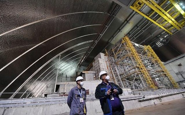 Employees stand inside the New Safe Confinement (NSC) new metal dome designed and built by French consortium Novarka encasing the destroyed reactor at Chernobyl plant on July 10, 2019, in Chernobyl. (Sergei Supinsky/AFP) Employees stand inside the New Safe Confinement (NSC) new metal dome designed and built by French consortium Novarka encasing the destroyed reactor at Chernobyl plant on July 10, 2019, in Chernobyl. (Sergei Supinsky/AFP)