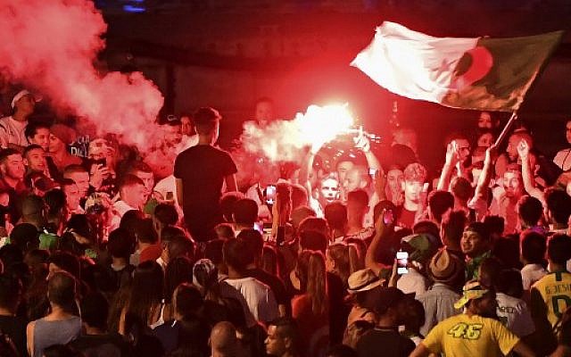Algeria supporters celebrate after Algeria won the 2019 Africa Cup of Nations (CAN) semi-final soccer match against Nigeria, at the old harbor in Marseille, southern France, on July 14, 2019. (Boris HORVAT/AFP) Algeria supporters celebrate after Algeria won the 2019 Africa Cup of Nations (CAN) semi-final soccer match against Nigeria, at the old harbor in Marseille, southern France, on July 14, 2019. (Boris HORVAT/AFP)