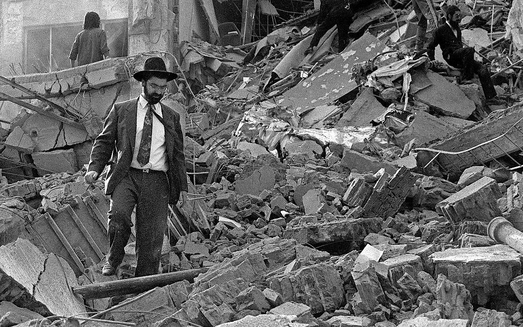 A man walks over the rubble left after of the Argentinian Israeli Mutual Association (AMIA) building in Buenos Aires after it was targeted in a deadly bombing, July 18, 1994 (Ali Burafi/AFP) A man walks over the rubble left after of the Argentinian Israeli Mutual Association (AMIA) building in Buenos Aires after it was targeted in a deadly bombing, July 18, 1994 (Ali Burafi/AFP)