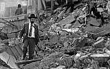 A man walks over the rubble left after of the Argentinian Israeli Mutual Association (AMIA) building in Buenos Aires after it was targeted in a deadly bombing, July 18, 1994 (Ali Burafi/AFP)