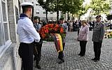 German Chancellor Angela Merkel presents a wreath of flowers during the memorial ceremony for the 75th anniversary of the attempted assassination of Adolf Hitler in Berlin, on July 20, 2019. (John MACDOUGALL / AFP)