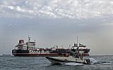 A picture taken on July 21, 2019, shows an Islamic Revolutionary Guard Corps ship patrolling around the British-flagged tanker Stena Impero, as it's anchored off the Iranian port city of Bandar Abbas. (Hasan Shirvani/Mizan News Agency/AFP)