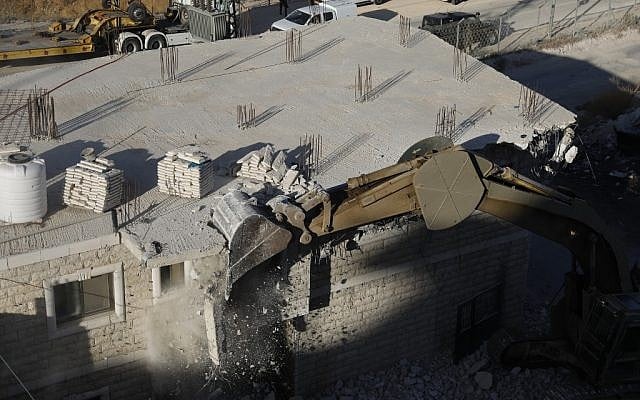 This picture taken on July 22, 2019 shows Israeli security forces demolishing the Palestinian buildings still under construction which have been issued notices to be demolished in the Wadi al-Hummus area adjacent to the Palestinian village of Sur Baher in East Jerusalem. (Photo by Ahmad GHARABLI / AFP) This picture taken on July 22, 2019 shows Israeli security forces demolishing the Palestinian buildings still under construction which have been issued notices to be demolished in the Wadi al-Hummus area adjacent to the Palestinian village of Sur Baher in East Jerusalem. (Photo by Ahmad GHARABLI / AFP)