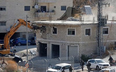 This picture taken July 22, 2019 shows Israeli security forces razing a Palestinian building under construction in the Wadi al-Hummus area adjacent to the East Jerusalem Palestinian village of Sur Baher. (Hazem Bader/AFP)