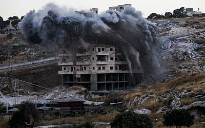 This picture taken on July 22, 2019, shows the demolition of a Palestinian building that was under construction in the East Jerusalem neighborhood of Sur Baher. (Ahmad GHARABLI / AFP)