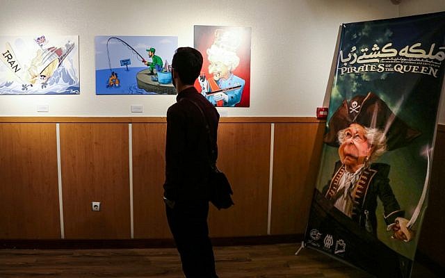 A man views caricatures at the 'Pirates of the Queen' cartoon exhibition showing artwork by Iranian artists portraying Britain's Queen Elizabeth II as a pirate over the seizure of an Iranian oil tanker earlier in the month, at the Osveh Art and Cultural Center in the capital Tehran on July 30, 2019. (Atta Kenare/AFP) A man views caricatures at the 'Pirates of the Queen' cartoon exhibition showing artwork by Iranian artists portraying Britain's Queen Elizabeth II as a pirate over the seizure of an Iranian oil tanker earlier in the month, at the Osveh Art and Cultural Center in the capital Tehran on July 30, 2019. (Atta Kenare/AFP)