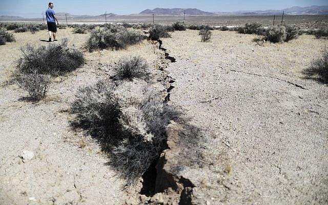 An onlooker views newly ruptured ground after a 7.1 magnitude earthquake struck in the area on July 6, 2019 near Ridgecrest, California. (Mario Tama/Getty Images/AFP) An onlooker views newly ruptured ground after a 7.1 magnitude earthquake struck in the area on July 6, 2019 near Ridgecrest, California. (Mario Tama/Getty Images/AFP)