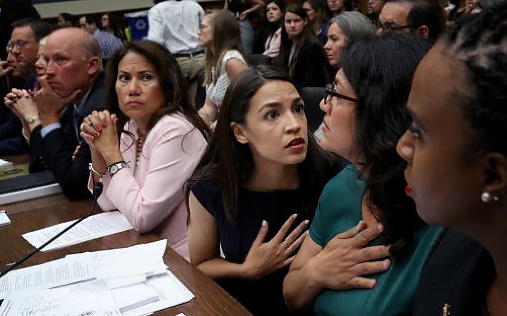 Rep. Alexandria Ocasio-Cortez (D-NY) (C) confers with U.S. Rep. Rashida Tlaib, (D-MI) (2nd R) and Rep. Ayanna S. Pressley (D-MA) (R) during a House Oversight and Reform Committee hearing July 12, 2019 in Washington, DC. (Win McNamee/Getty Images/AFP) Rep. Alexandria Ocasio-Cortez (D-NY) (C) confers with U.S. Rep. Rashida Tlaib, (D-MI) (2nd R) and Rep. Ayanna S. Pressley (D-MA) (R) during a House Oversight and Reform Committee hearing July 12, 2019 in Washington, DC. (Win McNamee/Getty Images/AFP)