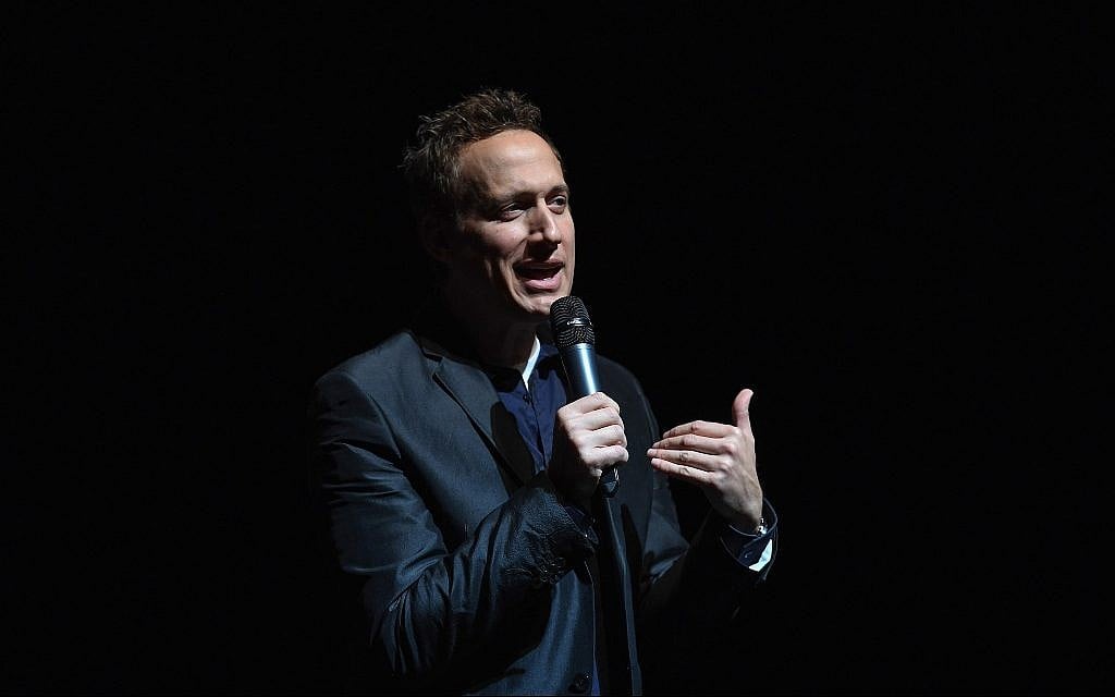 Comedian Elon Gold talks at John Jay College in New York, February 26, 2017. He has incorporated Jew-hatred into his comedy sets for years. (Shahar Azran/Getty Images/via JTA) Comedian Elon Gold talks at John Jay College in New York, February 26, 2017. He has incorporated Jew-hatred into his comedy sets for years. (Shahar Azran/Getty Images/via JTA)