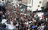 Mourners carry Palestinian and Hamas flags as they accompany the body of Mohammed Obeid, a 20 year-old Palestinian killed in a clashes with Israeli police on June 27, during his funeral in East Jerusalem, July 1, 2019. (AP Photo/Mahmoud Ilean)