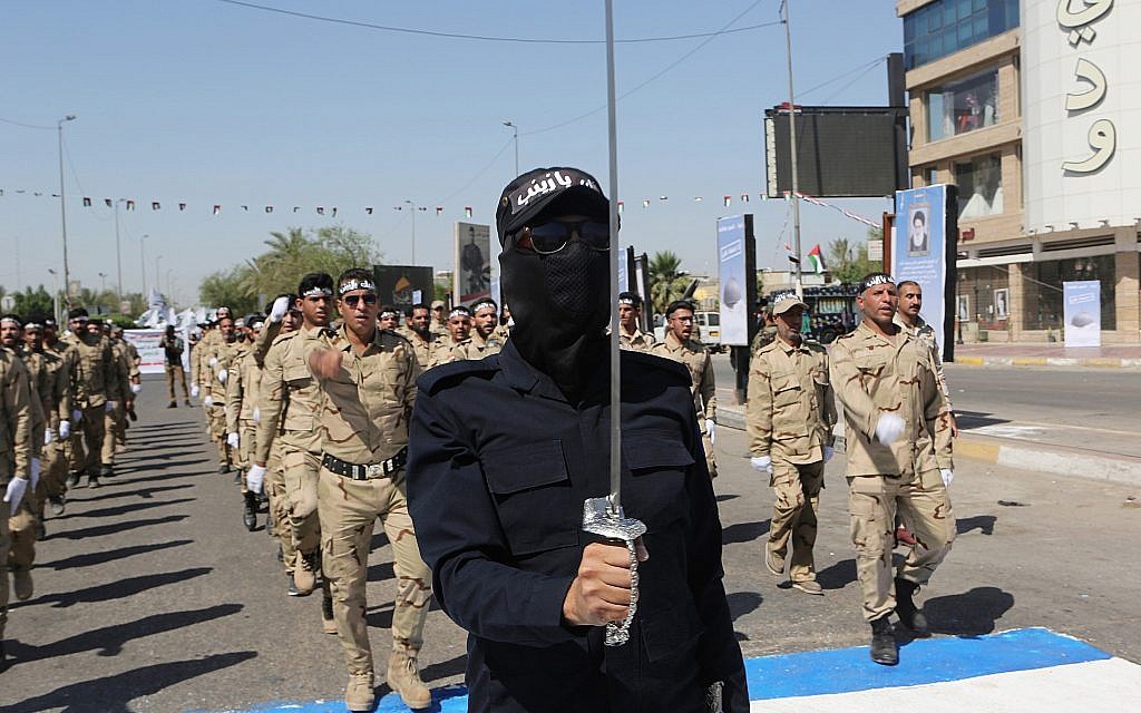 Iraqi Popular Mobilization Forces march in Baghdad, Iraq, May 31, 2019. (Khalid Mohammed/AP) Iraqi Popular Mobilization Forces march in Baghdad, Iraq, May 31, 2019. (Khalid Mohammed/AP)