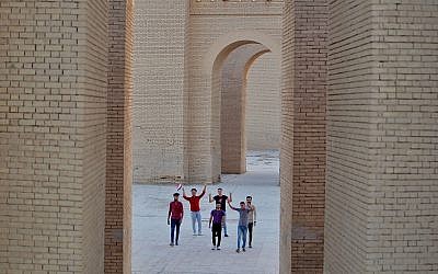 People celebrate at the archaeological site of Babylon, Iraq, Friday, July 5, 2019. Iraq on Friday celebrated the UNESCO World Heritage Committee's decision to name the historic city of Babylon a World Heritage Site in a vote held in Azerbaijan's capital, years after Baghdad began campaigning for the site to be added to the list. (AP Photo/Anmar Khalil)