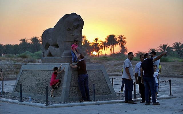 People stand near the Lion of Babylon at the archaeological site of Babylon, Iraq, Friday, July 5, 2019.(AP Photo/Anmar Khalil) People stand near the Lion of Babylon at the archaeological site of Babylon, Iraq, Friday, July 5, 2019.(AP Photo/Anmar Khalil)