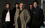 An undated promotional handout still from the Iranian state TV series, 'Gando,' shows actor Payam Dehkordi, center, who plays a character apparently based on Washington Post journalist Jason Rezaian, among other actors. (Mohammad Bagheri/TV series, 'Gando,' via AP)