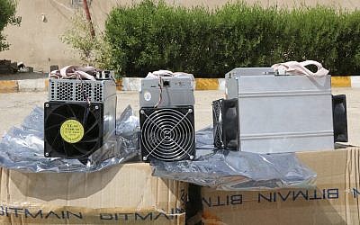 This undated photo provided by the Police News Agency, shows boxes of machinery used in Bitcoin 'mining' operations that were confiscated by police in Nazarabad, Iran. (News.police.ir via AP)