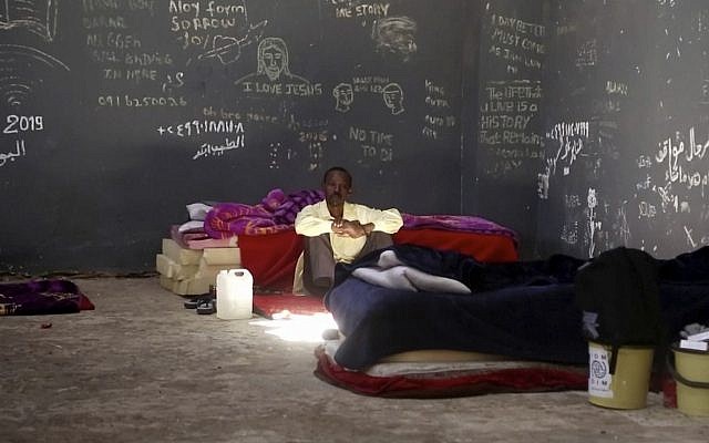 In this July 17, 2019 frame grab from video, a migrant rests in a detention center in the city of Sabha, about 650 kilometers, or 400 miles, south of the Libyan capital Tripoli. (AP Photo) In this July 17, 2019 frame grab from video, a migrant rests in a detention center in the city of Sabha, about 650 kilometers, or 400 miles, south of the Libyan capital Tripoli. (AP Photo)