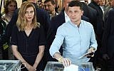 Ukrainian President Volodymyr Zelensky, right, and his wife Olena Zelenska cast their ballots at a polling station during a parliamentary election in Kiev, Ukraine on July 21, 2019. (AP/Evgeniy Maloletka)