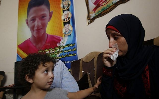 Raeda, mother of 14-year-old Mohammed Ayyoub, sits near a poster with his photo, at the family home in Jabaliya refugee camp, July 2, 2019. Mohammed was killed during a protest on the fence separating Israel and Gaza in 2018. (AP Photo/Hatem Moussa) Raeda, mother of 14-year-old Mohammed Ayyoub, sits near a poster with his photo, at the family home in Jabaliya refugee camp, July 2, 2019. Mohammed was killed during a protest on the fence separating Israel and Gaza in 2018. (AP Photo/Hatem Moussa)