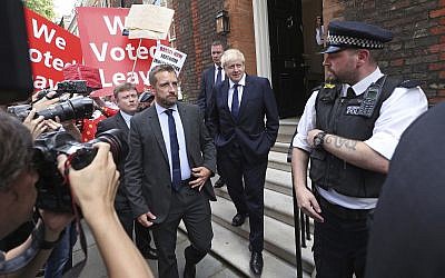 Conservative Party leadership contender Boris Johnson, center right, leaves his office in the Westminster area of London, July 22, 2019. (Yui Mok/PA via AP)