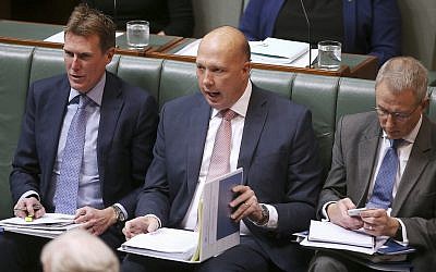 In this July 23, 2019, photo, Australian Home Affairs Minister Peter Dutton, center, interjects during debate in Parliament House in Canberra. (AP Photo/Rod McGuirk)