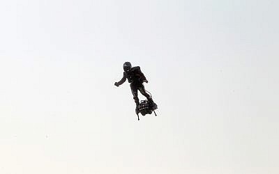Franky Zapata, a 40-year-old inventor, takes to the air in Sangatte, northern France, at the start of his attempt to cross the channel from France to England, July 25, 2019. (AP Photo/Michel Spingler)