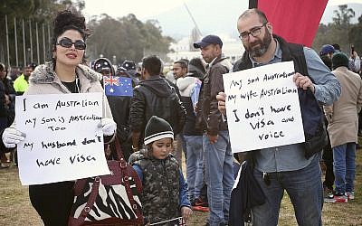 Lida Aftahi, left, her husband Heydar Aftahi, right, and their 4-year-old son, Ramssin, take part in a refugee protest at Parliament House in Canberra, Australia, July 29, 2019. (AP Photo/Rod McGuirk)