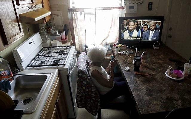 Carrie Newson watches television in the dining area inside her home at the Dutch Village apartments, in Baltimore, July 30, 2019. (Julio Cortez/AP) Carrie Newson watches television in the dining area inside her home at the Dutch Village apartments, in Baltimore, July 30, 2019. (Julio Cortez/AP)