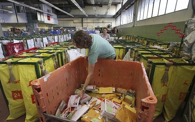 Israeli postal workers sort mail at a post office in Tel Aviv, February 22, 2010. (AP/Dan Balilty) Israeli postal workers sort mail at a post office in Tel Aviv, February 22, 2010. (AP/Dan Balilty)
