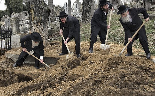 Rabbis rebury remains of 60 Holocaust victims killed by Romanian troops, which were found in a mass grave in Popricani, northern Romania. The reinterred them at the Jewish cemetery in Iasi, Romania, Monday, April 4, 2011. (AP Photo/Radu Aneculaesi/Proimage) Rabbis rebury remains of 60 Holocaust victims killed by Romanian troops, which were found in a mass grave in Popricani, northern Romania. The reinterred them at the Jewish cemetery in Iasi, Romania, Monday, April 4, 2011. (AP Photo/Radu Aneculaesi/Proimage)