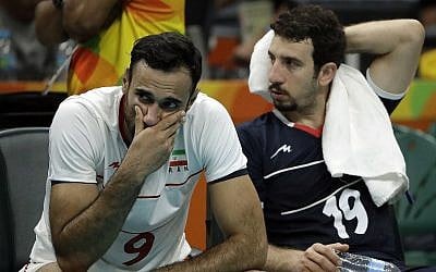 Iranian volleyball players Adel Gholami (L) and Mahdi Marandi after losing a men's quarterfinal volleybal lmatch against Italy at the 2016 Summer Olympics in Rio de Janeiro, Brazil, August 17, 2016. (AP Photo/Matt Rourke/File)