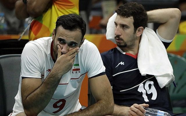 Iranian volleyball players Adel Gholami (L) and Mahdi Marandi after losing a men's quarterfinal volleybal lmatch against Italy at the 2016 Summer Olympics in Rio de Janeiro, Brazil, August 17, 2016. (AP Photo/Matt Rourke/File)