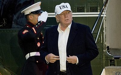 US President Donald Trump steps off Marine One on the South Lawn at the White House in Washington, December 17, 2017, after returning from Camp David in Maryland. (AP Photo/Andrew Harnik)