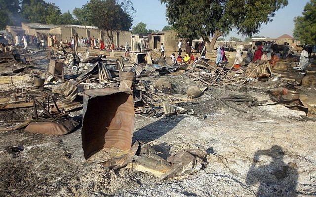 Illustrative: People gather at the site of an attack in Maiduguri, Nigeria, on November 1, 2018, after dozens of attackers overpowered soldiers guarding the camp and fighting continued for about two hours. (AP Photo/Jossy Ola) Illustrative: People gather at the site of an attack in Maiduguri, Nigeria, on November 1, 2018, after dozens of attackers overpowered soldiers guarding the camp and fighting continued for about two hours. (AP Photo/Jossy Ola)
