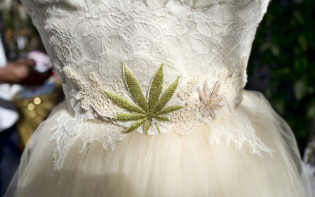 A wedding dress with an embroidered marijuana leaf on the front was displayed at the High Vibe Bride booth during the Cannabis Wedding Expo in Los Angeles in January 2019 (AP Photo/Richard Vogel) A wedding dress with an embroidered marijuana leaf on the front was displayed at the High Vibe Bride booth during the Cannabis Wedding Expo in Los Angeles in January 2019 (AP Photo/Richard Vogel)