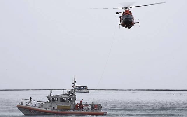 Illustrative -- A US Coast Guard Station Los Angeles-Long Beach 45-foot Response Boat-Medium crew conducts a hoist demonstration with a Coast Guard Air Station San Francisco-Forward Operating Base Point Mugu MH-65 Dolphin helicopter crew in the Port of Los Angeles, on March 21, 2019 (Seaman Ryan Estrada/U.S. Coast Guard via AP) Illustrative -- A US Coast Guard Station Los Angeles-Long Beach 45-foot Response Boat-Medium crew conducts a hoist demonstration with a Coast Guard Air Station San Francisco-Forward Operating Base Point Mugu MH-65 Dolphin helicopter crew in the Port of Los Angeles, on March 21, 2019 (Seaman Ryan Estrada/U.S. Coast Guard via AP)