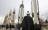 An Iranian clergyman looks at domestically built surface to surface missiles displayed by the Revolutionary Guard in a military show marking the 40th anniversary of the Islamic Revolution, at Imam Khomeini Grand Mosque in Tehran, Iran, February 3, 2019. (Vahid Salemi/AP)