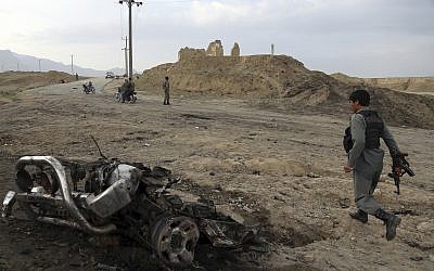 Illustrative: Afghan security forces gather at the site of an attack near the Bagram Air Base, north of Kabul, Afghanistan, April 9, 2019. (Rahmat Gul/AP)