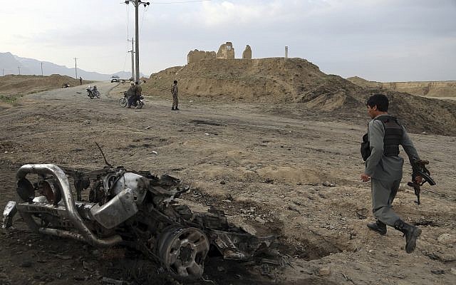 Illustrative: Afghan security forces gather at the site of an attack near the Bagram Air Base, north of Kabul, Afghanistan, April 9, 2019. (Rahmat Gul/AP) Illustrative: Afghan security forces gather at the site of an attack near the Bagram Air Base, north of Kabul, Afghanistan, April 9, 2019. (Rahmat Gul/AP)