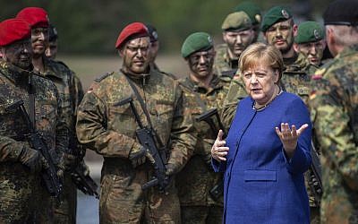 German Chancellor Angela Merkel, right, talks to soldiers of the Very High Readiness Joint Task Force (VJTF) after an exercise in Munster, Germany, May 20, 2019. In 2019 Germany will be in charge for the NATO Very High Readiness Joint Task Force. (Christophe Gateau/dpa via AP)