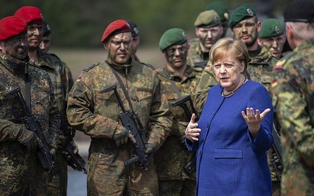 German Chancellor Angela Merkel, right, talks to soldiers of the Very High Readiness Joint Task Force (VJTF) after an exercise in Munster, Germany, May 20, 2019. In 2019 Germany will be in charge for the NATO Very High Readiness Joint Task Force. (Christophe Gateau/dpa via AP) German Chancellor Angela Merkel, right, talks to soldiers of the Very High Readiness Joint Task Force (VJTF) after an exercise in Munster, Germany, May 20, 2019. In 2019 Germany will be in charge for the NATO Very High Readiness Joint Task Force. (Christophe Gateau/dpa via AP)