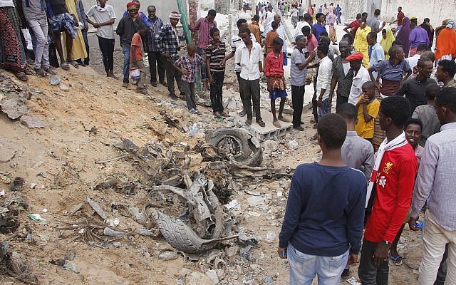 Illustrative: Somali people gather near destroyed buildings after a car bomb detonated in Mogadishu, Somalia, July 8, 2019. (AP Photo / Farah Abdi Warsameh) Illustrative: Somali people gather near destroyed buildings after a car bomb detonated in Mogadishu, Somalia, July 8, 2019. (AP Photo / Farah Abdi Warsameh)