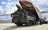 Military vehicles and equipment, parts of the S-400 air defense systems, are unloaded from a Russian transport aircraft, at Murted military airport in Ankara, Turkey, July 12, 2019. (Turkish Defence Ministry via AP, Pool)
