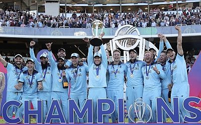 England's captain Eoin Morgan lifts the trophy after winning the Cricket World Cup final match between England and New Zealand at Lord's cricket ground in London, England, July 14, 2019. England won the Cricket World Cup for the first time in extraordinary circumstances, beating New Zealand by a tiebreaker of boundaries scored after the match was tied after regulation play and then the first Super Over in the tournament's history. (AP Photo/Aijaz Rahi)