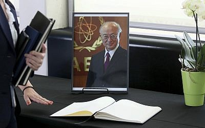 A book of condolence in front of a portrait of the late director general of the IAEA, Yukiya Amano, in Vienna, Austria, July 22, 2019. (AP Photo/Ronald Zak)